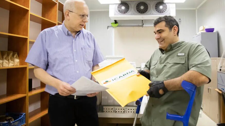 Dr. Hassan Machlab handing over the sealed seed packets to Michael Haddad in Terbol, Lebanon.