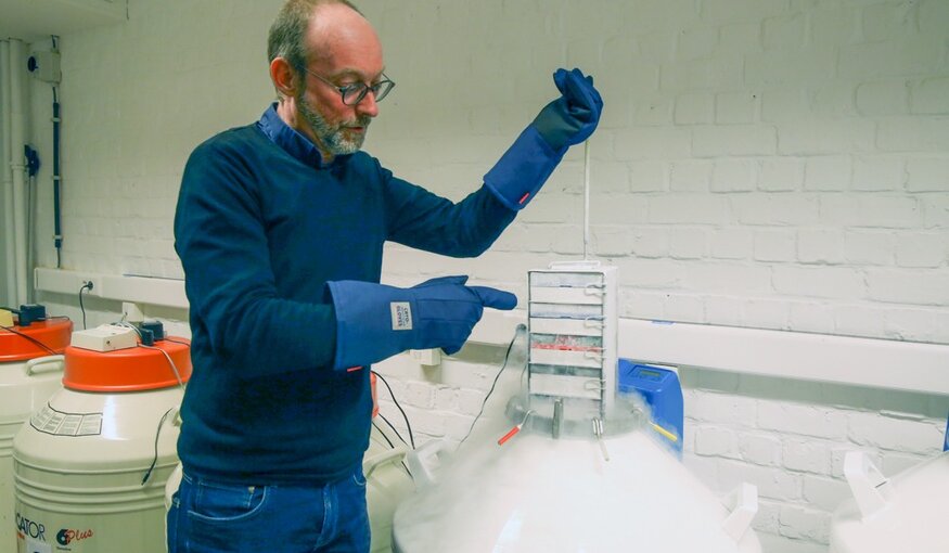 Man displaying cryopreserved samples.