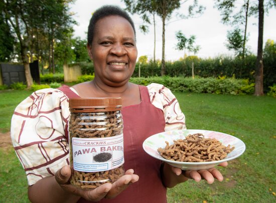 Farmer Pascilisa Wanyonyi holding her product ‘crackies’ under her brand name PAWA Bakers made with finger millet. 