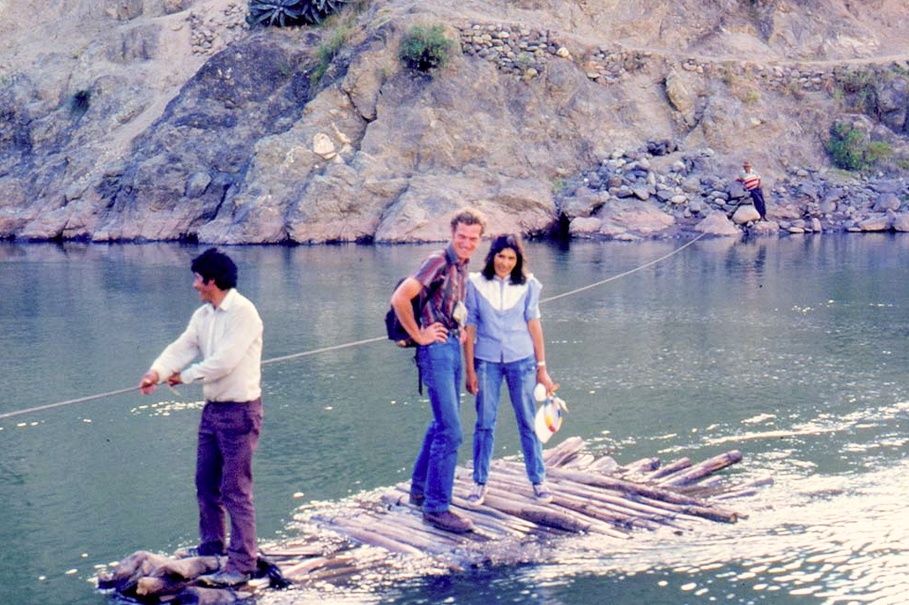 Dr. Debouck with two other people crossing a river. 