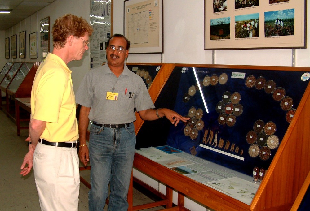Dr. Upadhyaya giving a man a tour of the ICRISAT genebank.